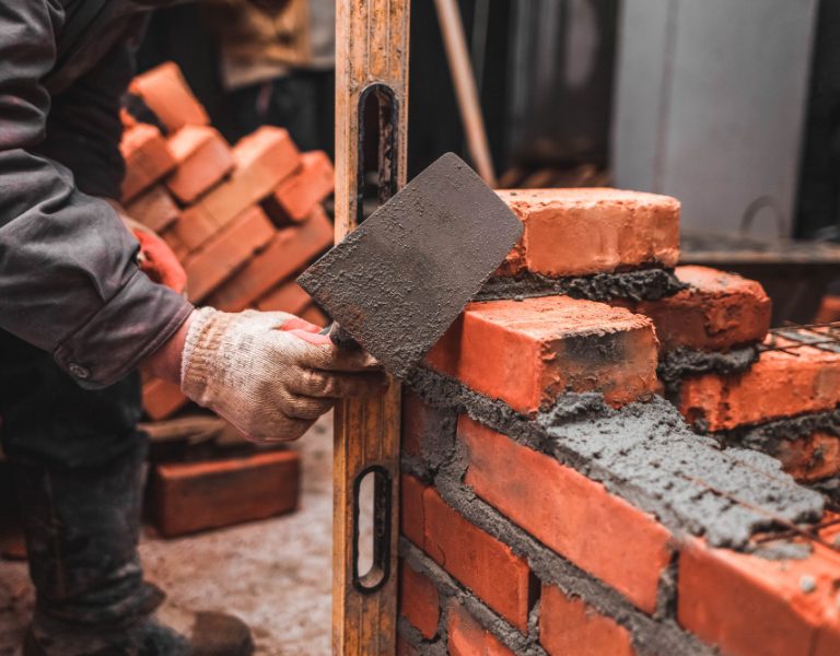 bricklayer-puts-bricks-make-wall.jpg