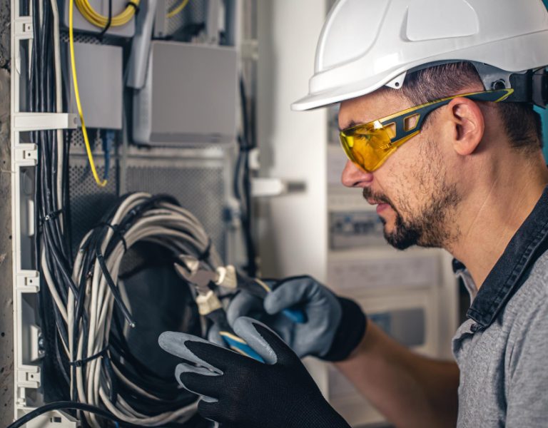 man-electrical-technician-working-switchboard-with-fuses.jpg