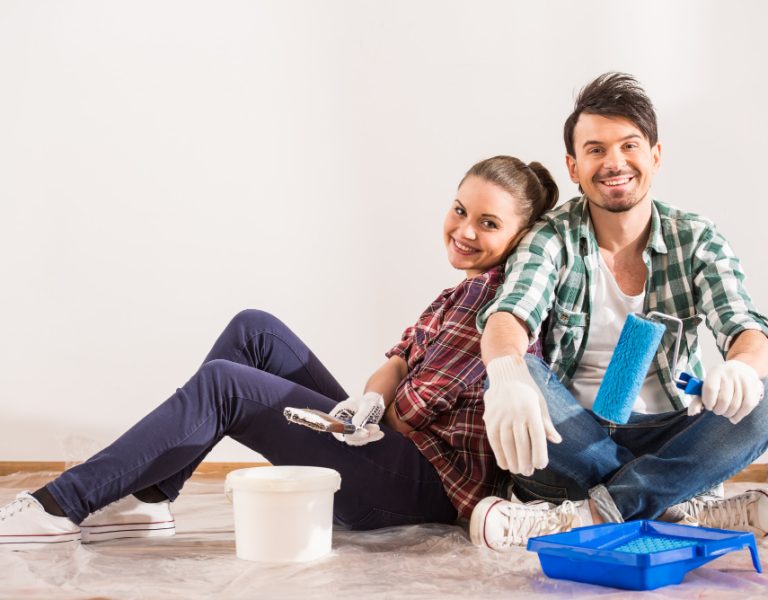 tired-young-couple-are-sitting-floor-with-paint-brush.jpg